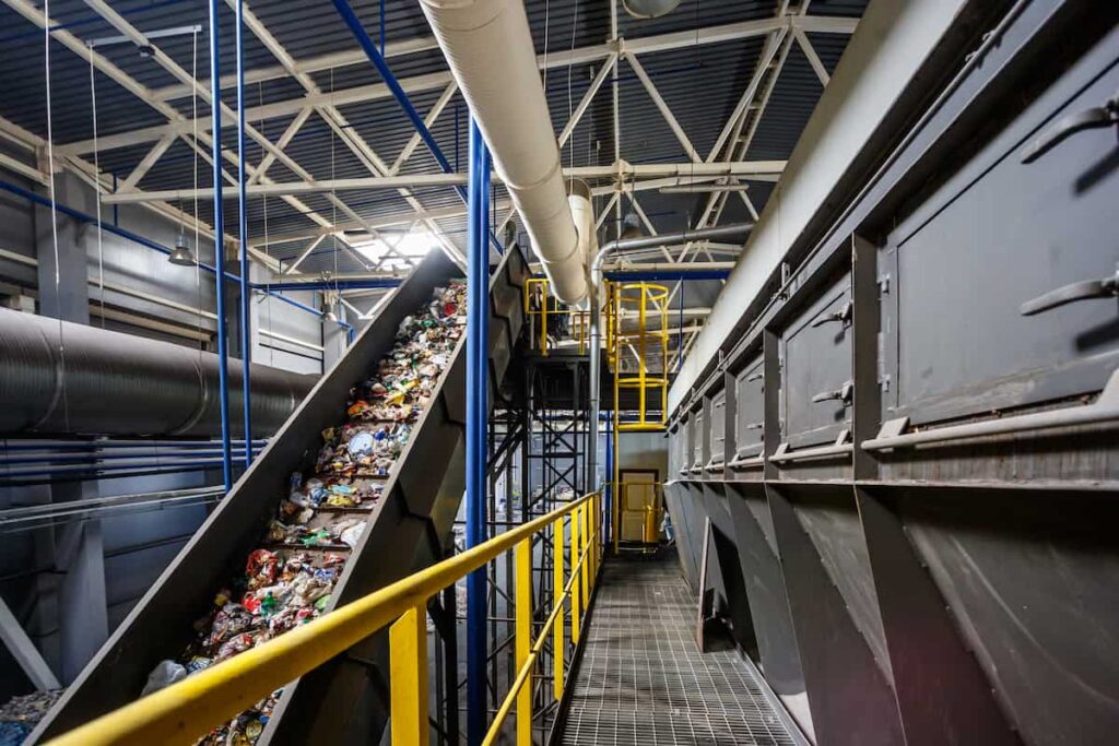 Conveyor belt carrying waste inside recycling facility